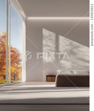 Modern bedroom with autumn view through large windows in serene setting 130858822
