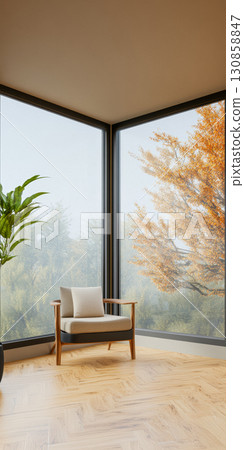 Cozy corner with modern chair and view of autumn trees in a serene indoor setting during daylight 130858847