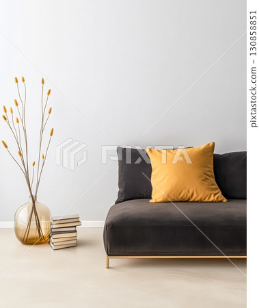 Modern minimalist living room with stylish sofa, decorative vase, and books arranged neatly Modern minimalist living room with stylish sofa, decorative vase, and books arranged neatly 130858851