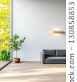 Modern interior design featuring a cozy sofa and indoor plant in a sunlit space 130858853