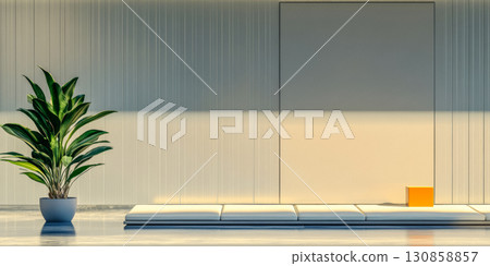 Minimalist indoor space features a potted plant beside a simple wall and a small orange cube in soft sunlight at midday 130858857