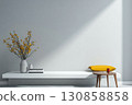 Bright and minimal indoor space with a yellow cushion and a vase of flowers on a white shelf 130858858
