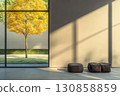 Bright autumn tree viewed through large window in modern interior with minimalist decor during afternoon light 130858859