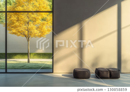 Bright autumn tree viewed through large window in modern interior with minimalist decor during afternoon light 130858859