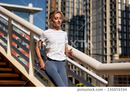 Woman jogging outdoors on a sunny day in an urban environment 130859394