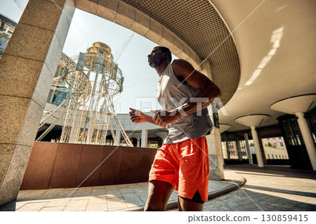 Man running under modern architecture in an urban environment 130859415
