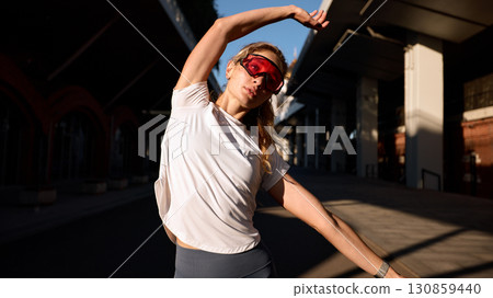 Active woman exercising in urban area during sunny day 130859440