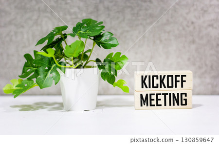A desk with wooden blocks. text Kickoff meeting A desk with wooden blocks. text Kickoff meeting 130859647