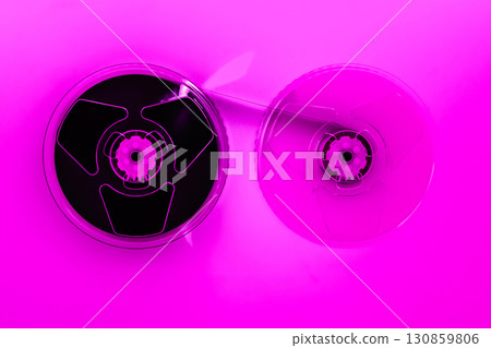 Abstract composition of video home system VHS tape reels in pink color effect 130859806