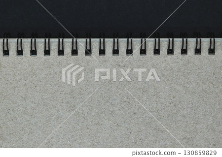 Background of Grey Notebook Cover with Black Metal Spirals with Free Copy Space 130859829