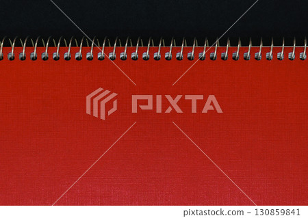 Background of Red Notebook Cover with Silver Metal Spirals with Free Copy Space Background of Red Notebook Cover with Silver Metal Spirals with Free Copy Space 130859841