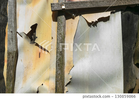 Background surface of old, brown, grey rusty wall from rubber and ruberoid Background surface of old, brown, grey rusty wall from rubber and ruberoid 130859866