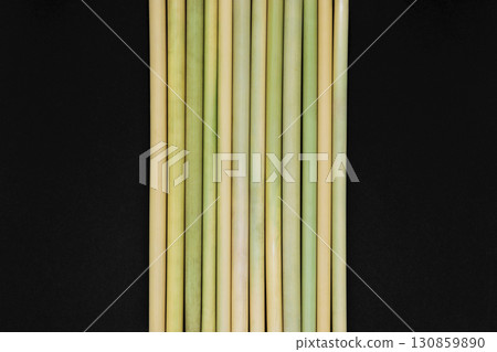 Bamboo sticks placed next to each other on black background surface 130859890