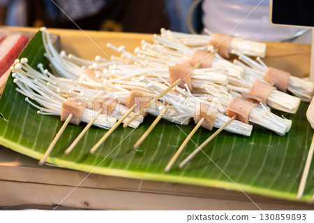 Barbeque spit of Enoki mushrooms and pork bacon in Thailand Barbeque spit of Enoki mushrooms and pork bacon in Thailand 130859893