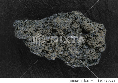 Black lava rock from Batur volcano placed on black stone background surface Black lava rock from Batur volcano placed on black stone background surface 130859933