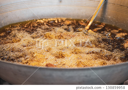 Boiling oil in metal bowl in Thailand market 130859958
