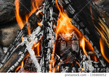 Burning bonfire with visible hot charcoal and ashes 130860052