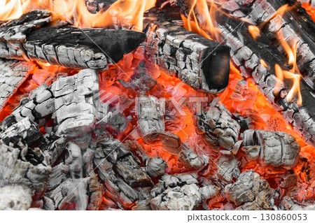 Burning bonfire with visible hot charcoal and ashes 130860053
