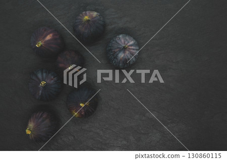 Common fig fruits on black stone background 130860115