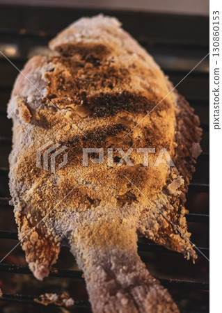 Fish covered with salt making on grill in Thailand market 130860153