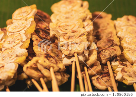 Grilled fruit snacks on wooden stick in Thailand market 130860196