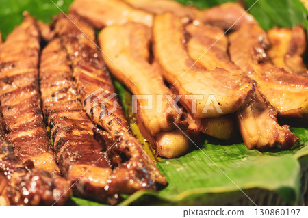 Grilled meat placed on banana leaf in Thailand market 130860197