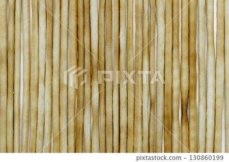 Group of baked italian bread sticks background on white background surface Group of baked italian bread sticks background on white background surface 130860199
