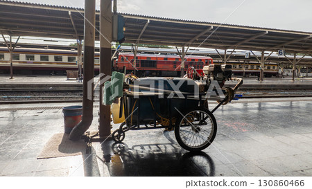 cleaning cart with hose and bucket at railway station, mobile trolley for platform sanitation, daily rail service and maintenance routine cleaning cart with hose and bucket at railway station, mobile trolley for platform sanitation, daily rail service and maintenance routine 130860466