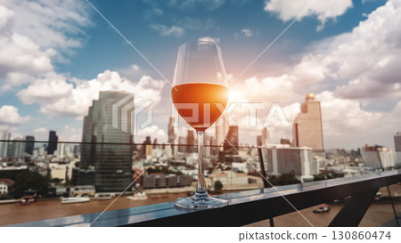 red wine on terrace with Bangkok city skyline at sunset, cocktail on rooftop, vibrant cityscape and luxury panorama view 130860474