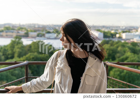 Young woman admiring cityscape from observation deck: feeling inspired by urban landscape Young woman admiring cityscape from observation deck: feeling inspired by urban landscape 130860672