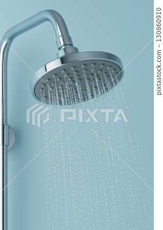 Modern shower head with running water on light blue wall hygiene and bathroom lifestyle photography 130860910