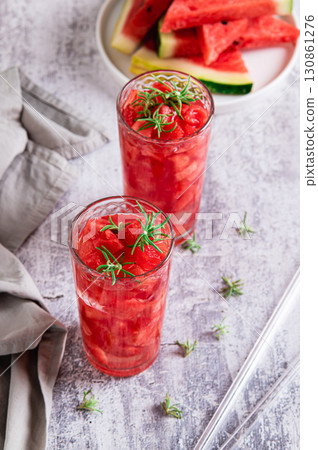 Refreshing watermelon rosemary detox drink in glasses on table vertical view Refreshing watermelon rosemary detox drink in glasses on table vertical view 130861276
