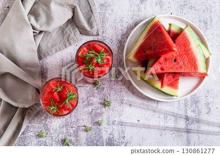 Detox summer drink with watermelon and rosemary in glasses on table top view Detox summer drink with watermelon and rosemary in glasses on table top view 130861277