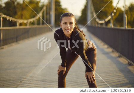 Portrait of happy smiling sporty woman looking at camera after sport fit exercises outdoors. Portrait of happy smiling sporty woman looking at camera after sport fit exercises outdoors. 130861529