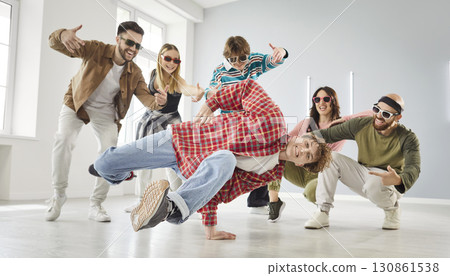 Group of happy young dancers enjoying break dance at a modern choreography studio Group of happy young dancers enjoying break dance at a modern choreography studio 130861538