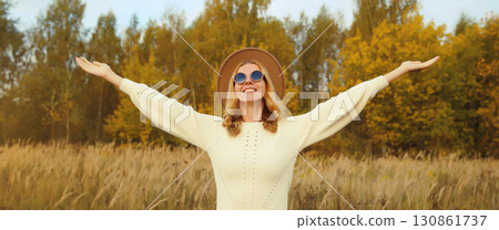 Happy stylish smiling woman in autumn park, joyful girl enjoying warm sunny weather, fall season Happy stylish smiling woman in autumn park, joyful girl enjoying warm sunny weather, fall season 130861737