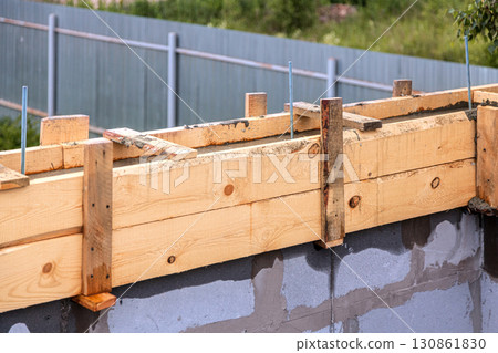Wooden formwork concrete strip foundation for a new house Wooden formwork concrete strip foundation for a new house 130861830