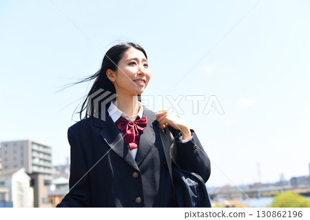Japanese high school girls smile and go to school under the blue sky Japanese high school girls smile and go to school under the blue sky 130862196