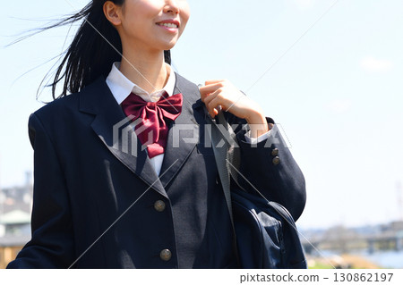 Japanese high school girls smile and go to school under the blue sky Japanese high school girls smile and go to school under the blue sky 130862197