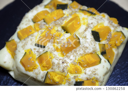 Steamed pumpkin buns on a stone plate 130862258