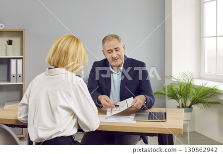 Real estate agent and customer meeting for house investment. Real estate agent and customer meeting for house investment. 130862942