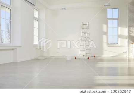 Empty light room with white painted walls and step ladder in new apartment. Empty light room with white painted walls and step ladder in new apartment. 130862947