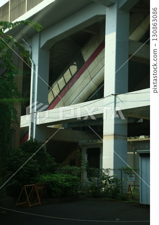 Escalators leading to the station seen from under the elevated tracks Escalators leading to the station seen from under the elevated tracks 130863086