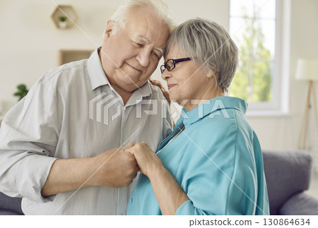 Happy loving married retired elderly man and woman are holding hands and smiling 130864634