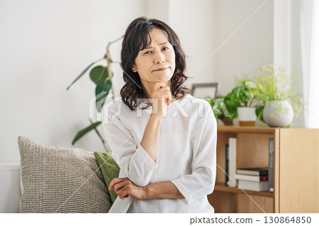A middle-aged woman in her 50s having trouble at home 130864850