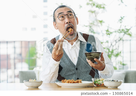 Senior man eating delicious food 130865014