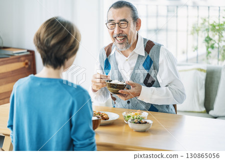 Senior couple having fun eating at home 130865056