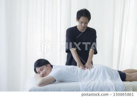Man receiving chiropractic treatment 130865861
