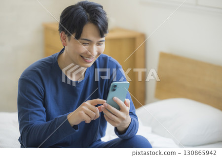 A young man looking at his smartphone 130865942