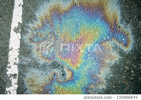 Vibrant Oil Slick Creates a Colorful Display on Asphalt Surface in Urban Setting Vibrant Oil Slick Creates a Colorful Display on Asphalt Surface in Urban Setting 130866645